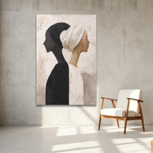 Load image into Gallery viewer, Abstract painting of two profiles on a concrete wall with a chair below.